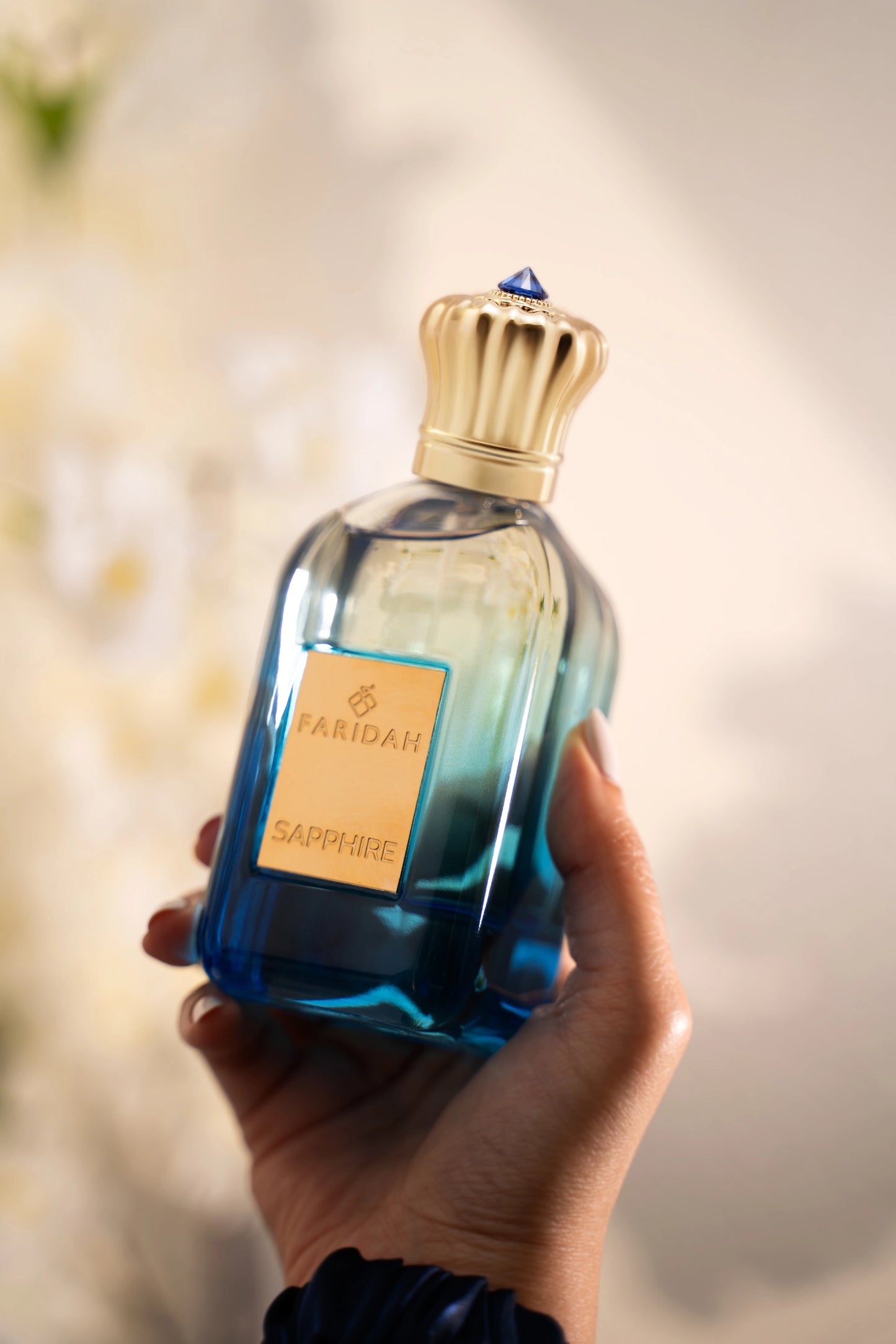 Sapphire by Faridah Gems Collection perfume bottle close-up elegant blue premium scent