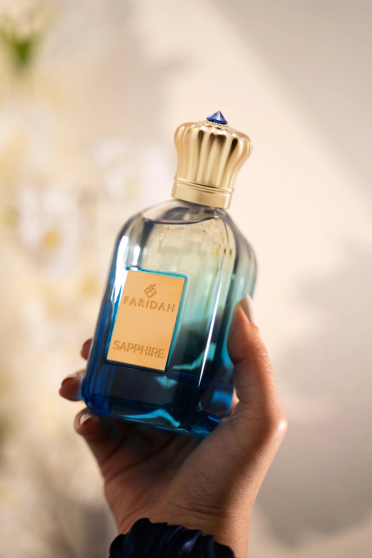Sapphire by Faridah Gems Collection perfume bottle close-up elegant blue premium scent