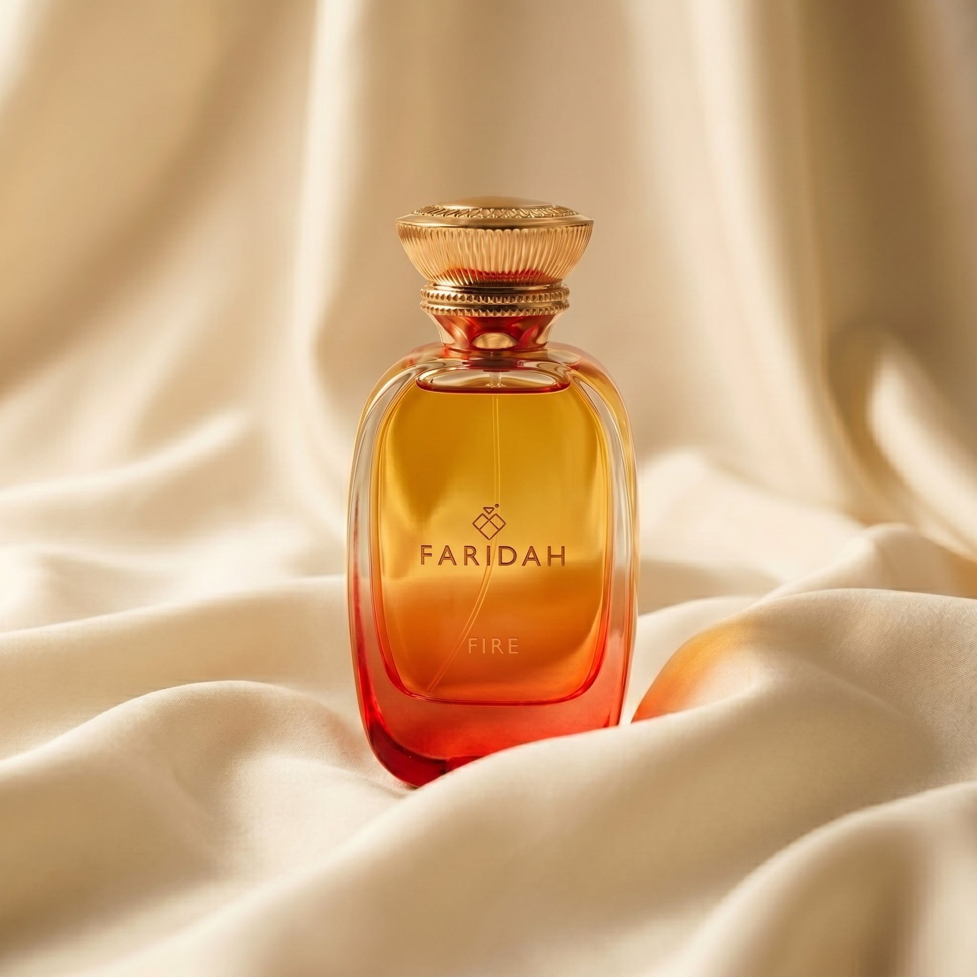 Fire - The Elements Collection Faridah luxury non-alcoholic perfume with amber-gold bottle on silk